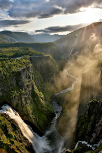 Scenic view of waterfall against sky