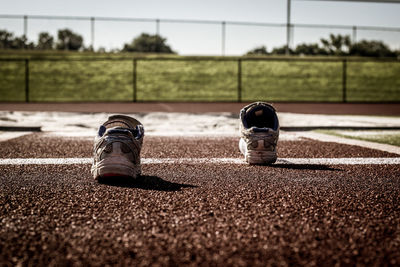 Close-up of sports shoes on running track field