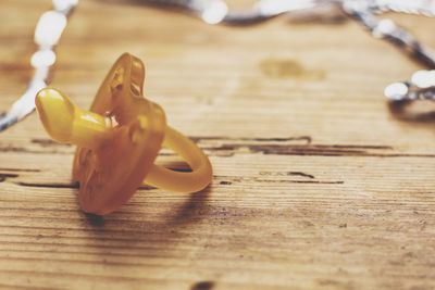 Close-up of pacifier on wooden table