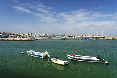 Boats moored in river against the sky