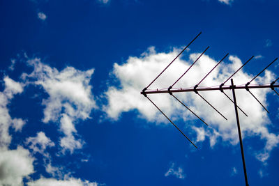 Low angle view of telephone pole against sky