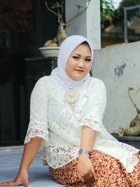 Indonesian women wear kebaya combined with white headscarves
