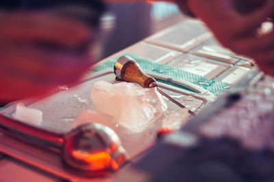 Close-up of hand holding ice cream on table