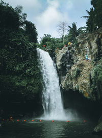 Scenic view of waterfall against sky