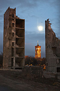 Illuminated tower in city against sky at night