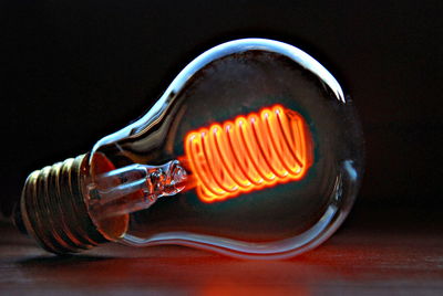 Close-up of light bulb against black background