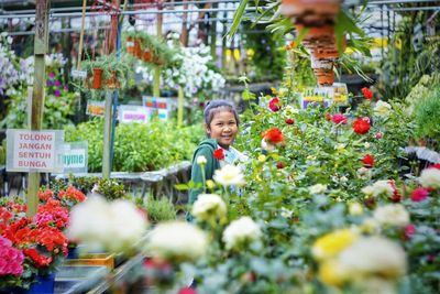 Women standing by flowering plants at store