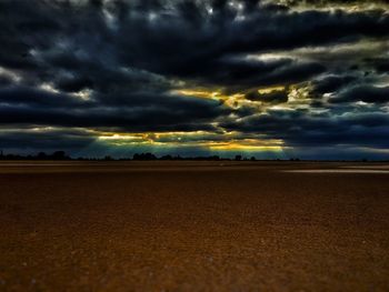 Scenic view of beach against cloudy sky