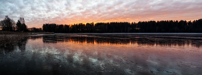 Scenic view of lake against sky during sunset