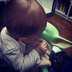 Rear view of boy sitting at home