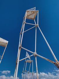 Low angle view of metallic structure against blue sky