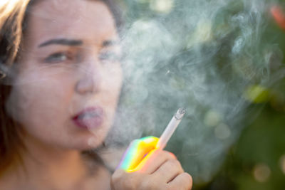 Close-up portrait of woman smoking cigarette