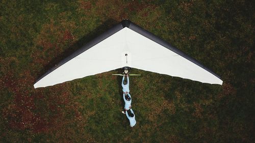 High angle view of paragliding on field