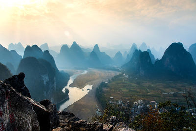 Scenic view of mountain against sky during sunrise