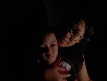 Portrait of mother with son in darkroom