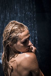 Shirtless young woman having bath