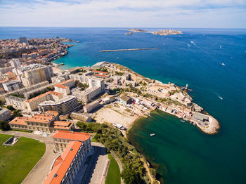 High angle view of sea and buildings against sky