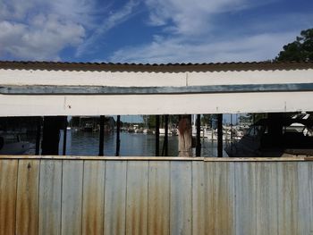 Scenic view of lake by building against sky