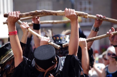 Folk dancers holding stick