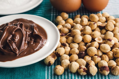Close-up of chocolate and hazelnuts on table