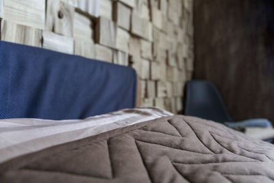 Close-up of sofa on bed against wall at home