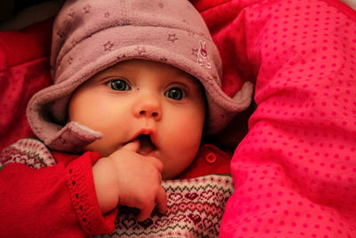 Portrait of cute baby girl in bed