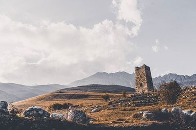 Scenic view of mountains against cloudy sky