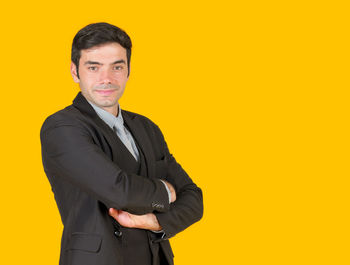 Portrait of a smiling man against yellow background