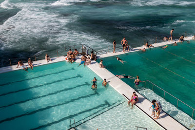 High angle view of people enjoying at beach