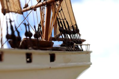 Close-up of sailboat in sea against sky