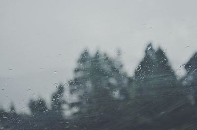 Man seen through wet window during rainy season