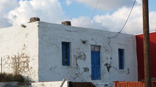 Low angle view of house against cloudy sky