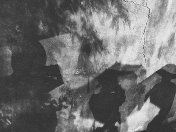 Digital composite image of people shadow on mirror