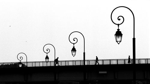 Street light against sky in city