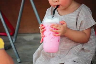 Midsection of woman drinking glass