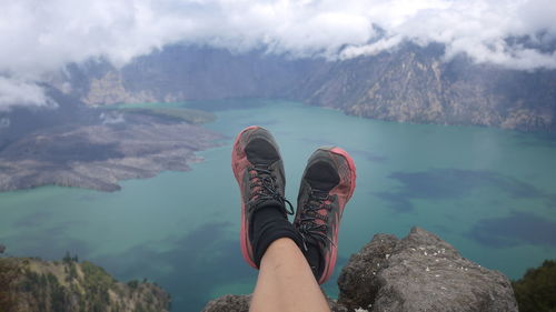 Low section of person on rock in mountains