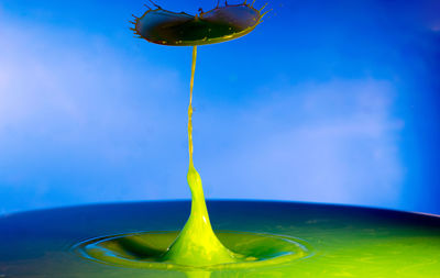 Close-up of green table against blue sky