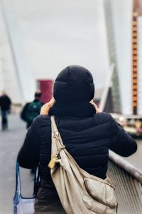 Rear view of man standing in city