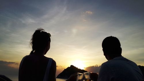 Rear view of couple looking at sunset