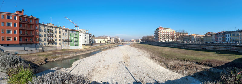 Panoramic view of canal amidst buildings against clear sky