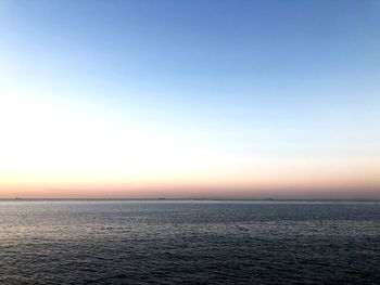 Scenic view of sea against clear sky during sunset