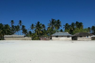 House on beach against blue sky