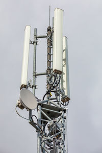 Low angle view of communications tower against sky