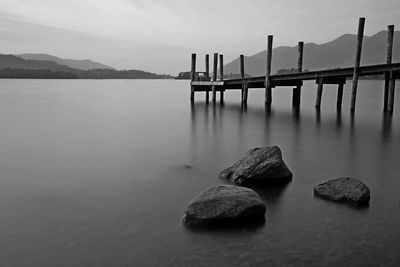 Scenic view of rocks in sea against sky