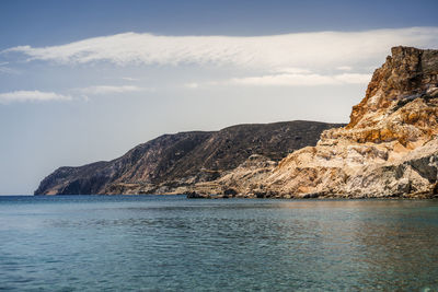 Scenic view of sea and mountains against sky