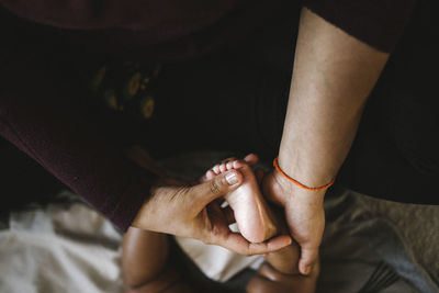 Mother massaging baby's foot
