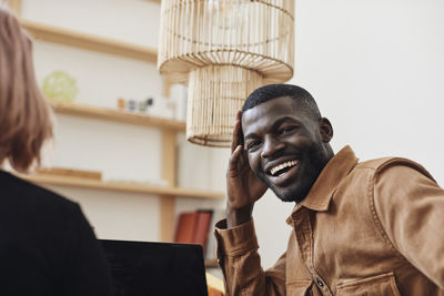 Portrait of happy male computer programmer at tech start-up office