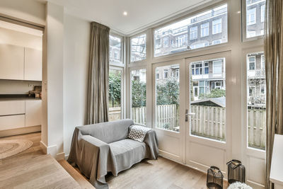 View of sofa by window in apartment