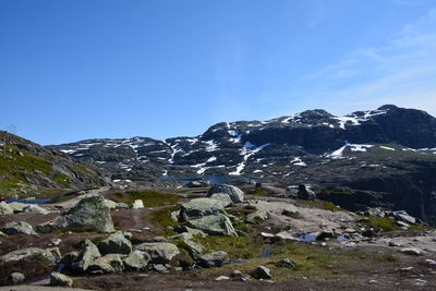 Scenic view of mountains against blue sky