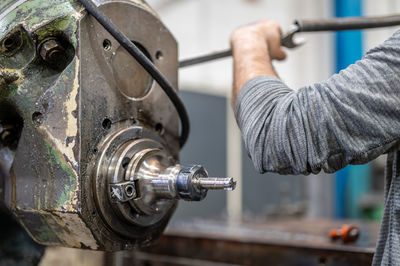 Cropped hand of man repairing car